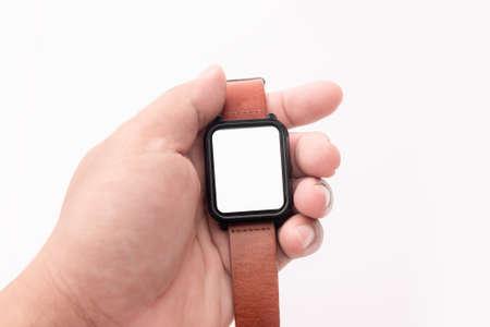 Hand holding Smart watch with brown genuine leather straps isolated on whiteの写真素材