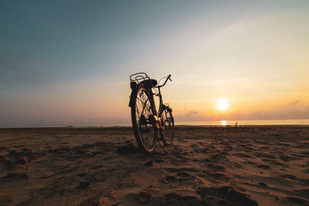 Vintage Bicycle on the beach at sunsetの写真素材