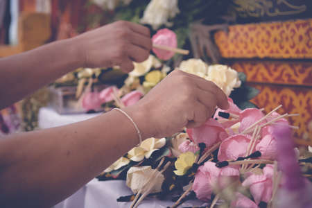 Woman putting Funeral Flower on coffin at funeral, Vintage toneの写真素材