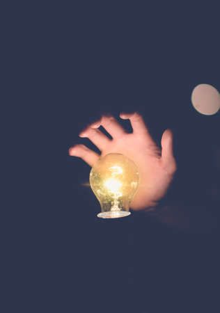 Light bulbs on handbokeh background Vintage tone.idea concept.の写真素材