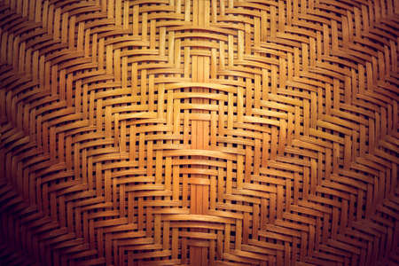 Bamboo weave basket texture and background with sunlight,Traditional woven and refinement in Thailandの写真素材