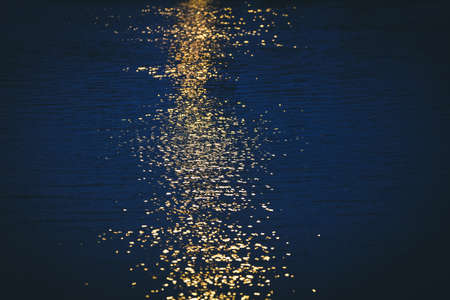 Abstract blur reflection of the sunset in the water.の写真素材