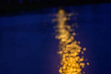 Abstract blur reflection of the sunset in the water.