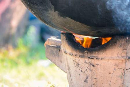 The Big iron pan touches the heat from the flame until the smoke comes out.の写真素材