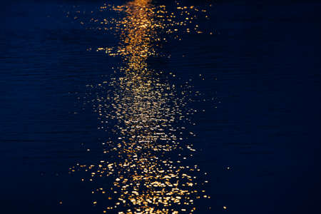 Abstract blur reflection of the sunset in the water.の写真素材