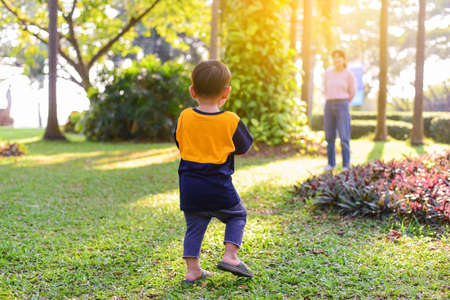 Happy family Children playing with Mother in the Park and enjoying the beautiful autumn nature.の写真素材