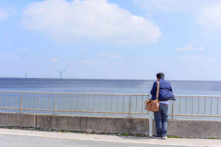 Young man standing to looking at the future, success concept.