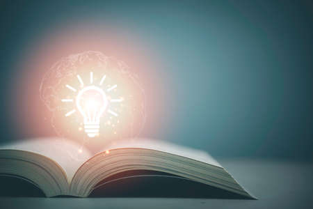 Light bulb on the Book and the world, Concept of reading books knowledge and searching for new ideas and opening up the world of knowledge Thinking and creative.の写真素材