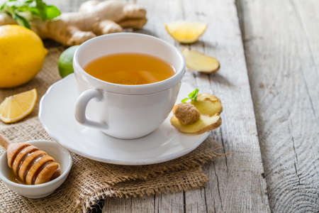 Ginger tea and ingredients on rustic wood background, copy spaceの写真素材