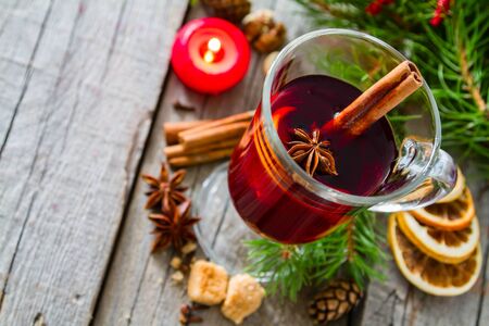 Mulled wine and ingredients on rustic wood backgroundの写真素材