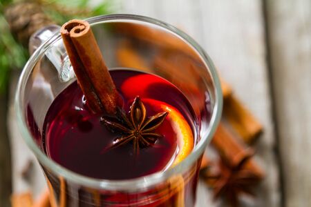 Mulled wine and ingredients on rustic wood backgroundの写真素材