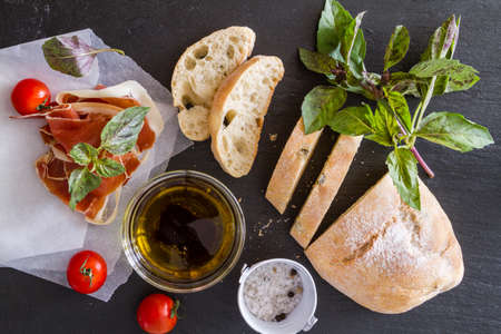 appetizer - ciabatta ham basil tomato, rustic wood background, top viewの写真素材