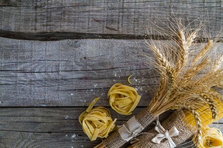Different pasta types, wheagt on rustic backgroundの写真素材