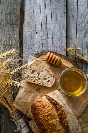 Sliced bread honey wheat rustic wood background, top view