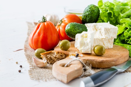greek salad ingredients on white wood backgroundの写真素材