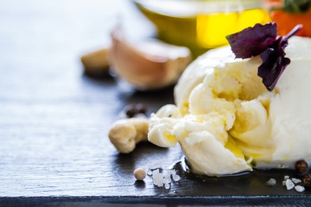 Caprese salad ingredients, dark stone background, closeupの写真素材