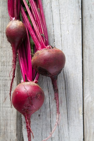 Raw beet on rustic wood background, copy space