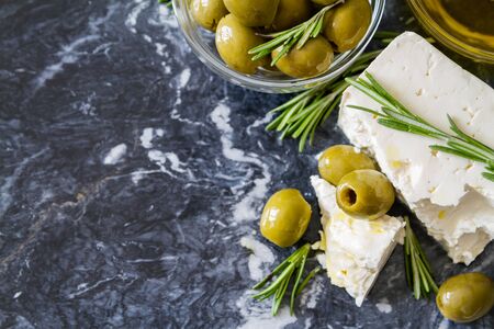Feta olives rosemary on marble board, closeupの写真素材