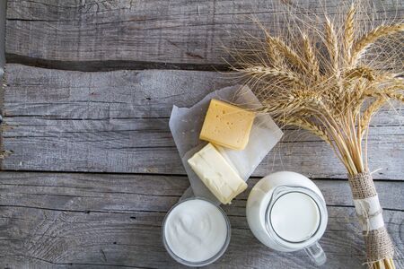 Selection of dairy products and wheat on rustic wood backgroundの写真素材