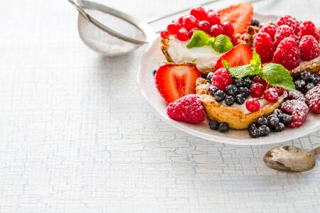 Berry cakes on light wood background closeupの写真素材