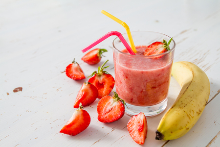 Banana strawberry smoothie ingredients white wood backgroundの写真素材