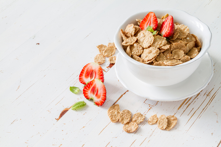 Breakfast - cereal and berries in white bowl, white wood backgroundの写真素材