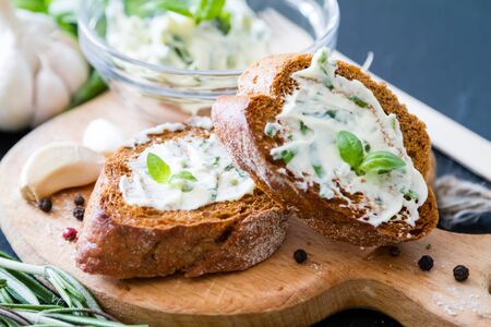 Garlic bread with herbs dark stone backgroundの写真素材