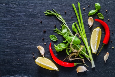 Selection of herbs and spices, dark stone background, top viewの写真素材