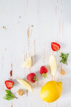 Strawberry lemonade ingredients with mint, white wood background, top viewの写真素材