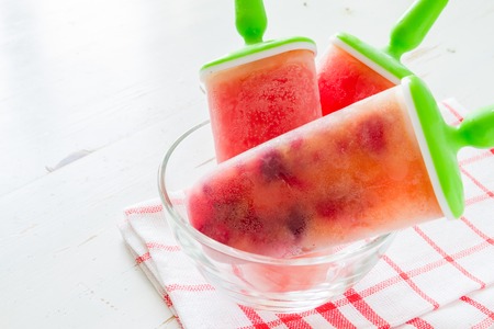 Fruit juice ice pops, white wood backgroundの写真素材