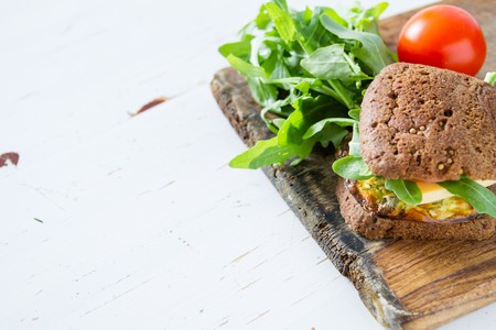 Vegan sandwich with salad and cheese, on white wood background, copy spaceの写真素材