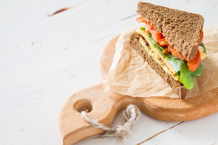 Vegan sandwich with salad and cheese, on white wood background, copy spaceの写真素材
