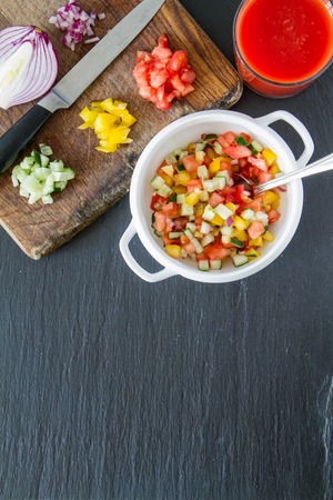Gazpacho soup and ingredients, dark stone background, top viewの写真素材