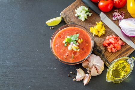Gazpacho soup and ingredients, dark stone background, top viewの写真素材