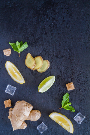 Ginger lemonade and ingredients, dark stone background, copy space, top viewの写真素材