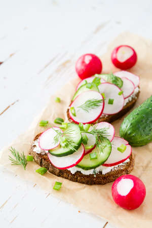 Radish and cucumber sandwich, white wood backgroundの写真素材