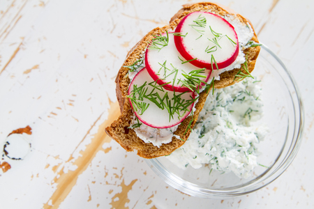 Radish and cucumber sandwich and ingredients, white wood backgroundの写真素材