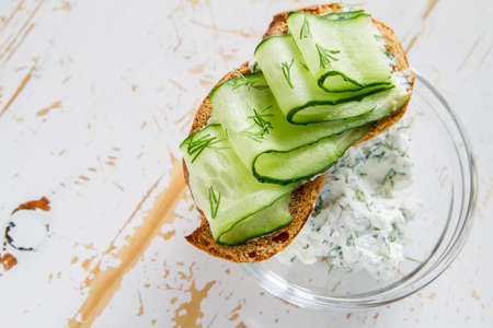 Radish and cucumber sandwich and ingredients, white wood backgroundの写真素材