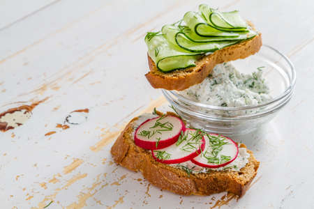 Radish and cucumber sandwich and ingredients, white wood backgroundの写真素材