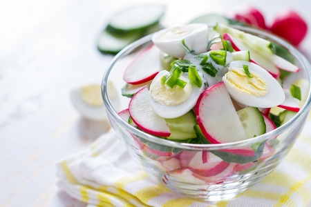 Radish salad and ingredients on white wood backgroundの写真素材