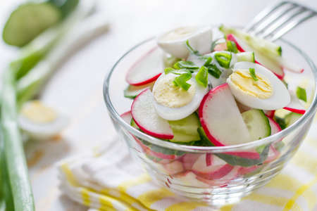 Radish salad and ingredients on white wood backgroundの写真素材