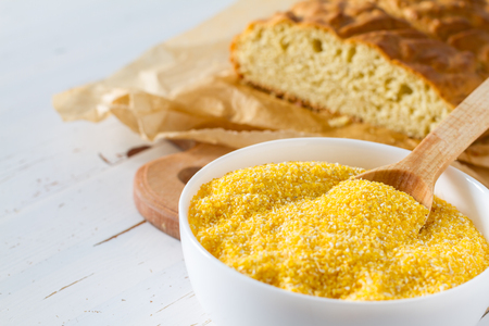 Corn bread cut in peaces on white wood background, copy spaceの写真素材