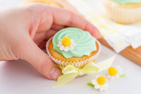 Spring cupcakes decoration on white wood backgroundの写真素材