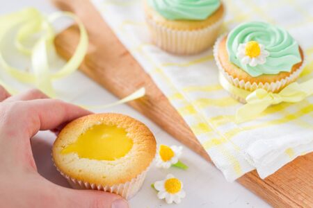 Spring cupcakes decoration on white wood background