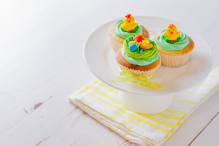 Easter cupcakes on white wood background, copy spaceの写真素材
