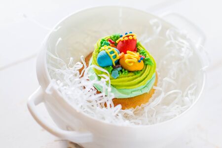 Easter cupcakes on white wood background, copy space