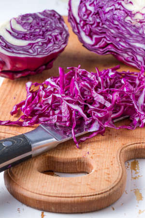Sliced red cabbage on wood board, closeupの写真素材