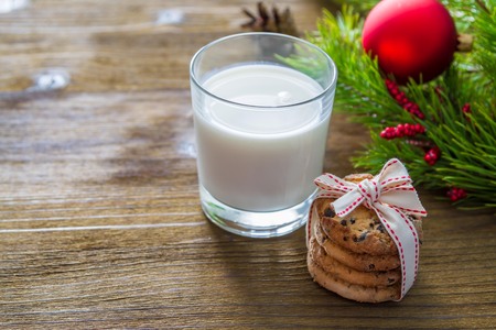 Cookies and milk for Santa Clause on wood background, copy spaceの写真素材