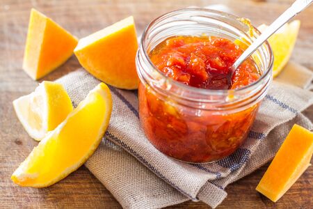 Orange and pumpkin jam ingredients, wood backgroundの写真素材
