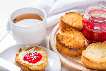 Toasts with butter and jam, white backgroundの写真素材